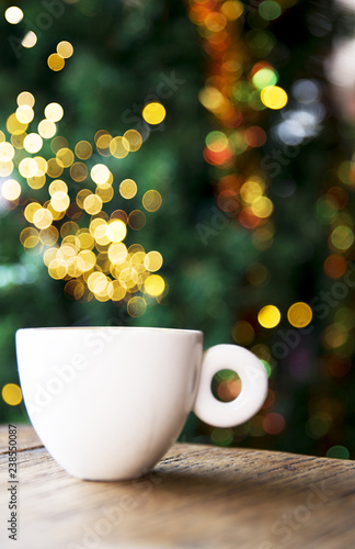 Tasty cappuccino with some blurred lights on Christmas tree.