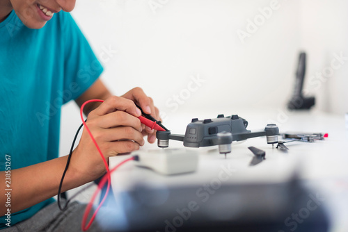 Boy repairing drone photo