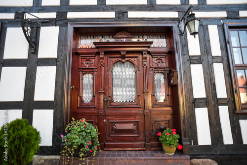 Old wooden door in half-timbered buildings. © Kozioł Kamila