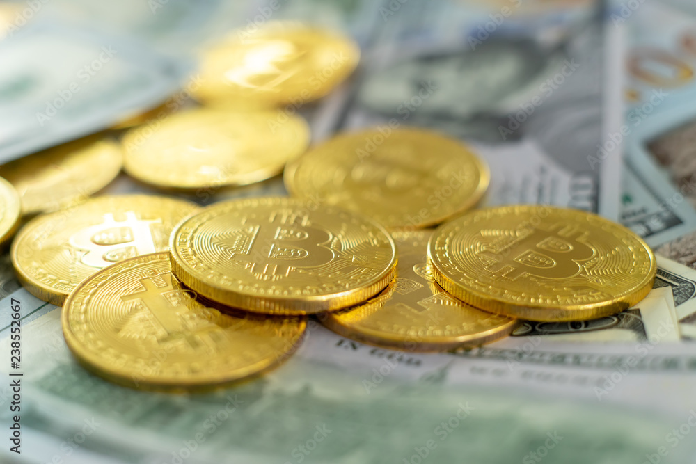 golden bitcoin coin on us dollars close up golden bitcoin coin on us dollars close up