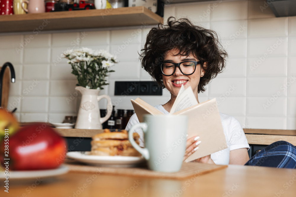 Smiling cheerful girl having tasty breakfast Smiling cheerful girl having tasty breakfast