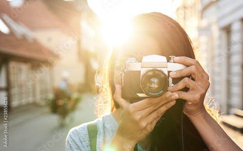 Photography Young woman taking photos in the old city