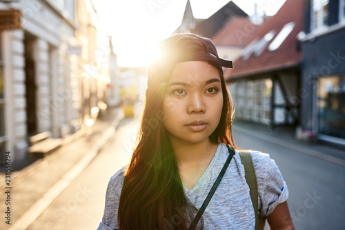 Stylish young Asian woman walking through the city photo