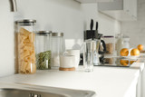 white kitchen with dishware, jars and food