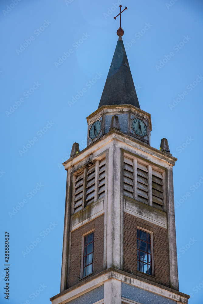 Dome or Bell tower of an old church with a clock in a day with a blue clean sky