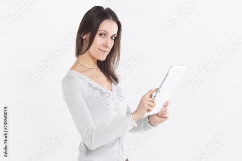 close up. a young businesswoman looks at the screen of a digital tablet .photo with copy space