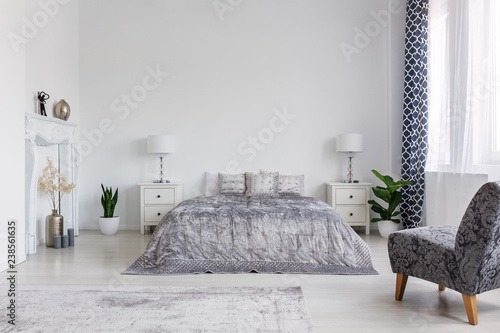 Trendy armchair in bedroom designed in new york style, real photo with copy space