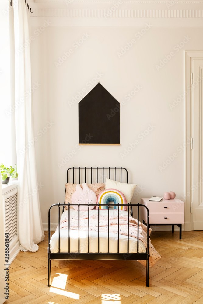 Black poster on white wall above bed in simple teenager's bedroom interior with cabinet. Real photo Black poster on white wall above bed in simple teenager's bedroom interior with cabinet. Real photo