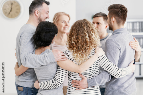 Men and women hugging each other during therapy for couples with problems photo