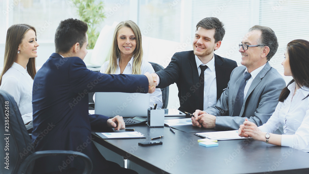 business partners shaking hands after a successful transaction business partners shaking hands after a successful transaction