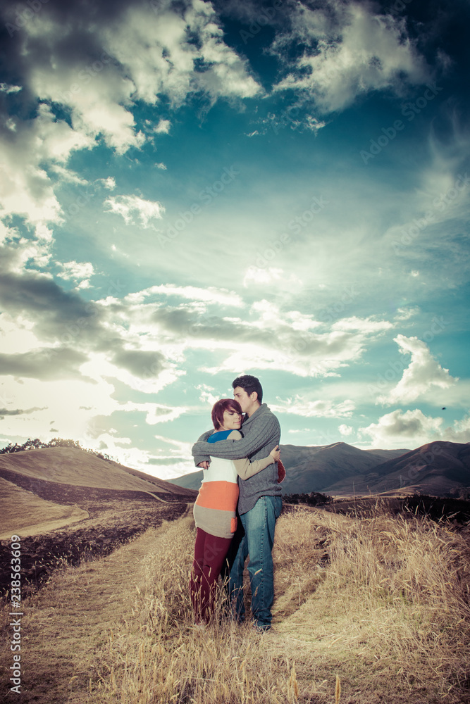 Young couple hugging on an open field Young couple hugging on an open field