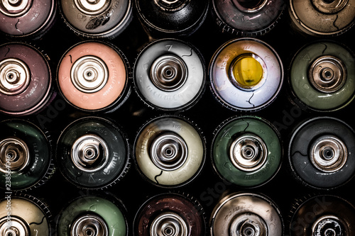 Canvas Print Colorful Aerosols/spray paint cans lined up together on table