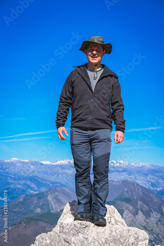 Tourist standing on huge rock in Lovcen NP