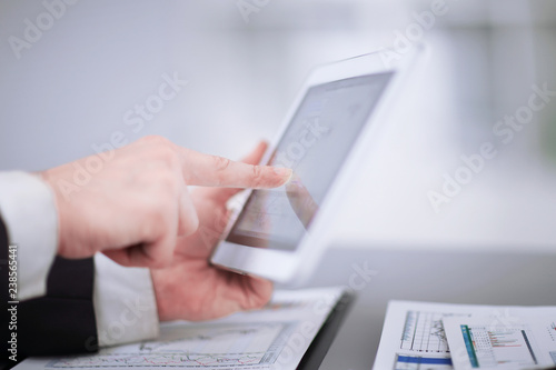 close up.businessman using digital tablet in the workplace