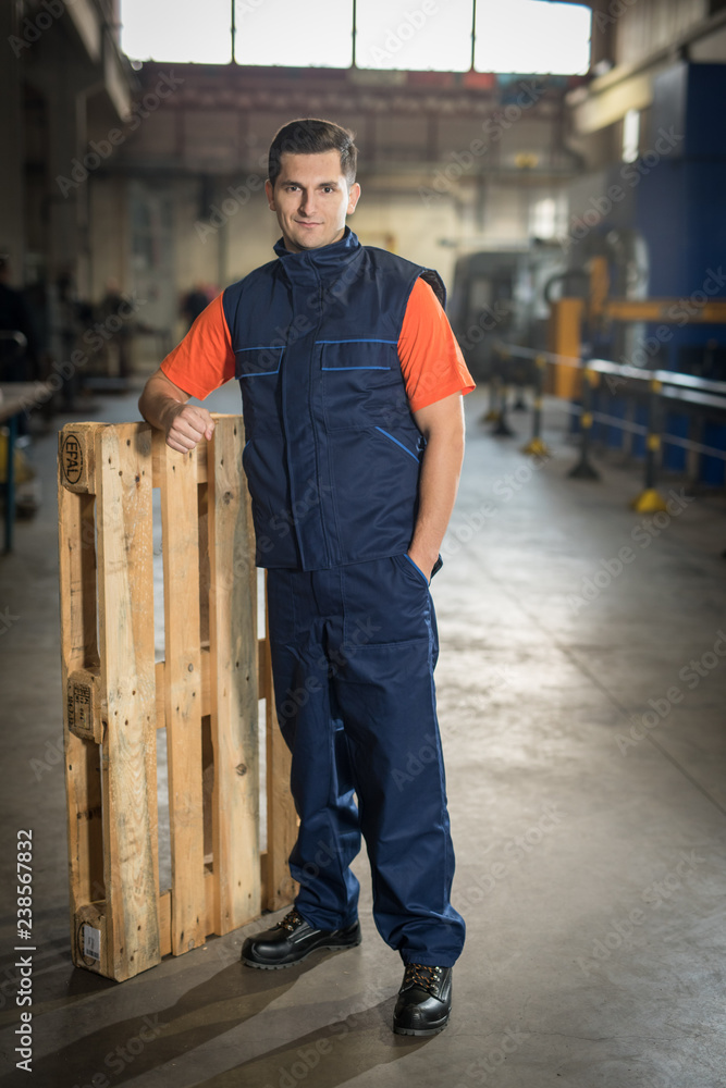 Engineer in protective suit doing his job inside factory Engineer in protective suit doing his job inside factory