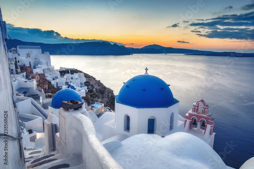 Beautiful view of Santorini island in Greece at sunrise with dramatic sky.