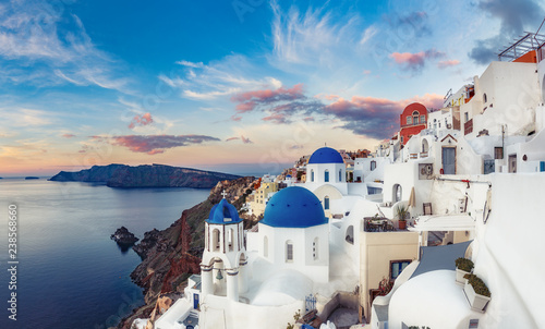 Beautiful view of Oia village on Santorini island in Greece at sunrise with dramatic sky.