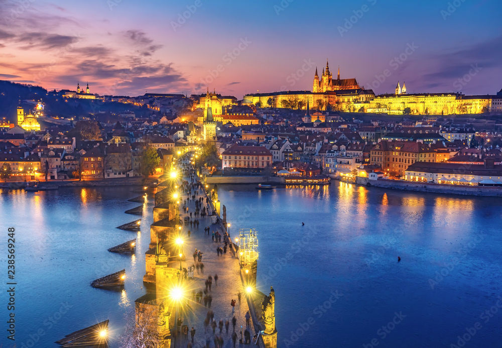 Scenic aerial view on Charles bridge and Prague castle in Prague, Czech Republic, at sunset. Beautiful travel background.
