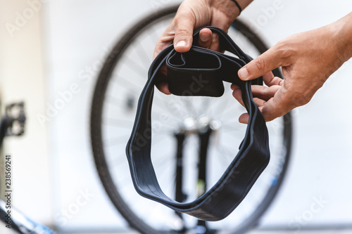 Cyclist hands are holding collapsed rubber bicycle camera