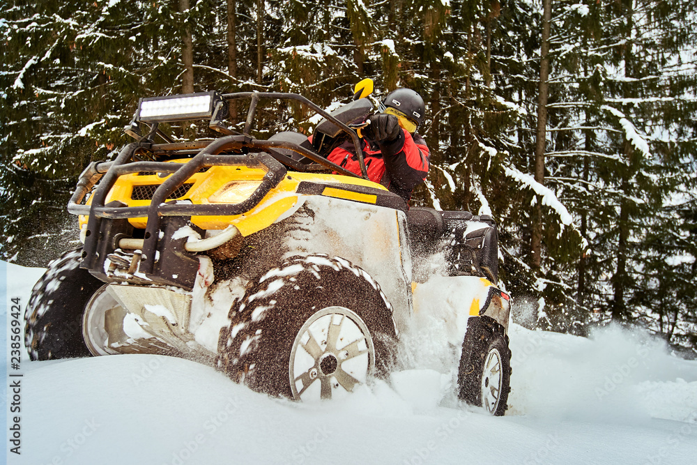 Winter race on an ATV on snow in the forest. Winter race on an ATV on snow in the forest.
