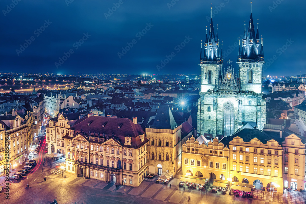Fototapeta premium Aerial view on Old town with Tyn church in Prague, Czech republic, at night. Colourful skyline.