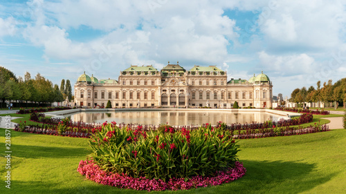 Belvedere palace panorama with a pond and flowers in front of.