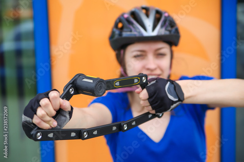 Girl with bicycle lock. Bicycle U- lock