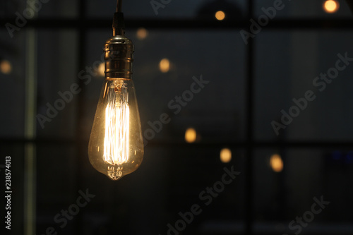 Classic edison lamp on a dark background. Cafe interior element. Mock-up.