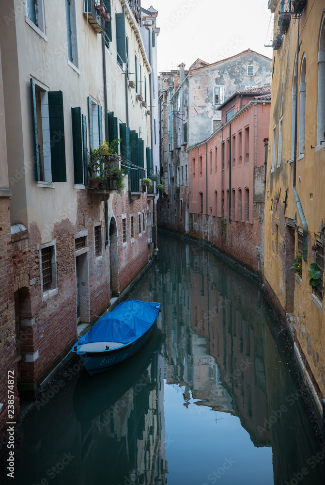 A narrow canal between the houses in Venice