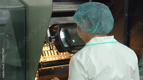 medical technician female assistant working in laboratory. pharmaceutical manufacturing industry factory, health care testing medication laboratory glass tubes virus vaccine vaccines quality control photo