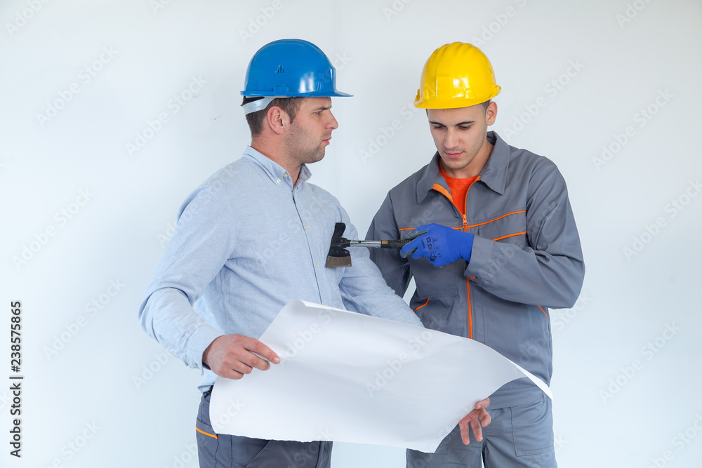 Two friendly male engineers discussing their project on white backgrond Two friendly male engineers discussing their project on white backgrond