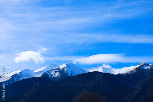 Fototapeta Naklejka Na Ścianę i Meble -  Mountain snow peak, beautiful natural winter backdrop. Ice top of the hill, blue sky background. Alpine landscape.