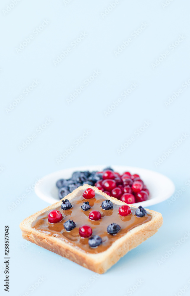 Toast with peanut butter and berries. Toast with peanut butter and berries.