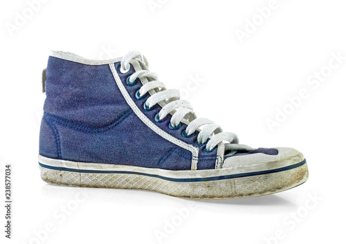 Old and dirty blue canvas sneakers on white background