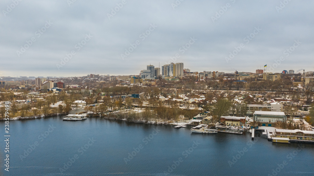 Aerial view from drone on the cityscape on the shore of Dnieper river in  Dnipro city, Ukraine.