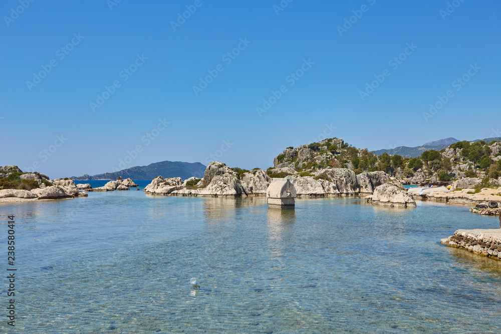 Coast of the island in the Mediterranean sea, picturesque with the ruins of ancient Lycian towns and tombs-sarcophagi of Aperlai, Simena Teimussa Dolihiste.