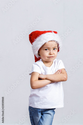 Little girl in santa hat on white background