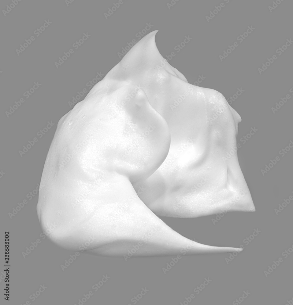 Gentle white cosmetic cream on gray background.