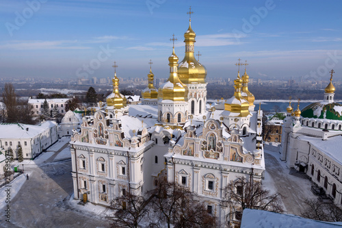 Winter view of the Kiev Monastery of the Caves and the Assumption cathedral on Dnieper river background photo