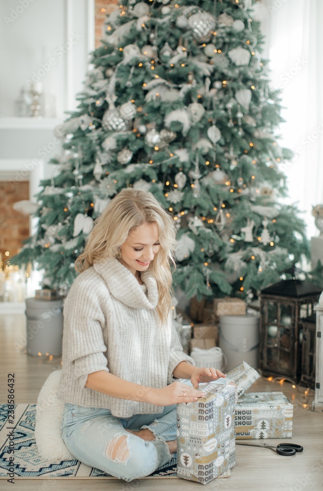 Happy blonde women in Christmas decorations with gifts Happy blonde women in Christmas decorations with gifts