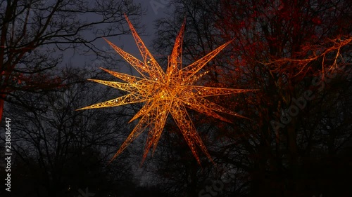 Christmas decoration Christmas star at dusk in a park photo