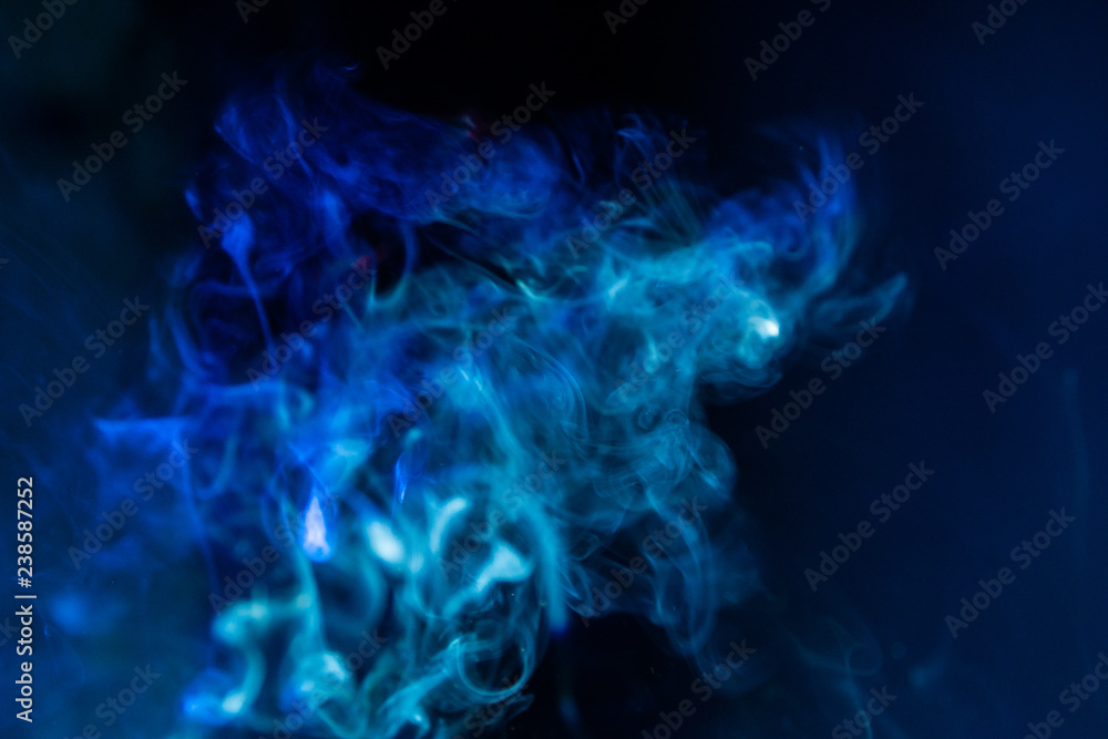 blurry smoke abstract background blue color on black night . free form swirl flowing fog in the air . blurry smoke abstract background blue color on black night . free form swirl flowing fog in the air .