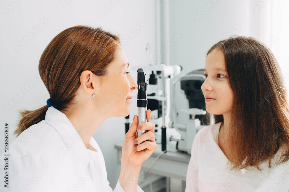 girl getting eye exam at doctors office. Children eye examination procedure, real patients girl getting eye exam at doctors office. Children eye examination procedure, real patients