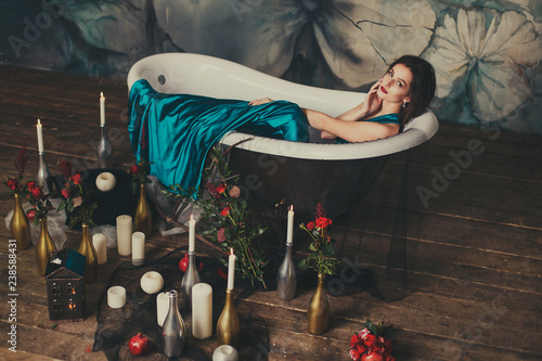 beautiful girl in a dress in the bath