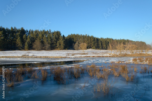 The river is covered with ice in winter