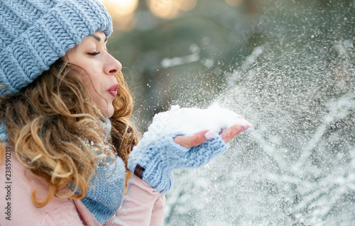 Attractive young curly woman in wintertime outdoor photo