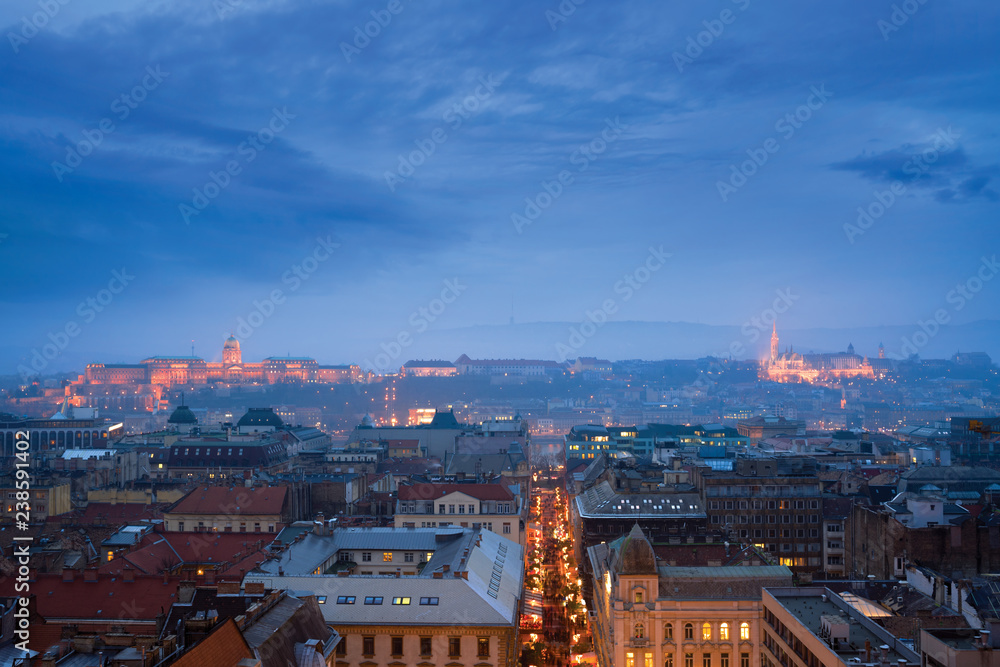 Panoramic view of Budapest city in the evening featuring Royal Palace and St. Matthew Cathedral