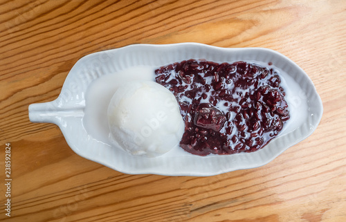 Traditional Thai dessert. Coconut ice cream served with black glutinous rice. photo