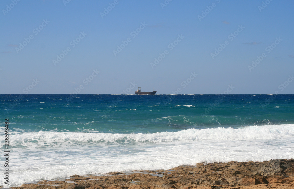 White foamy waves on a rocky shore of the Mediterranean sea White foamy waves on a rocky shore of the Mediterranean sea