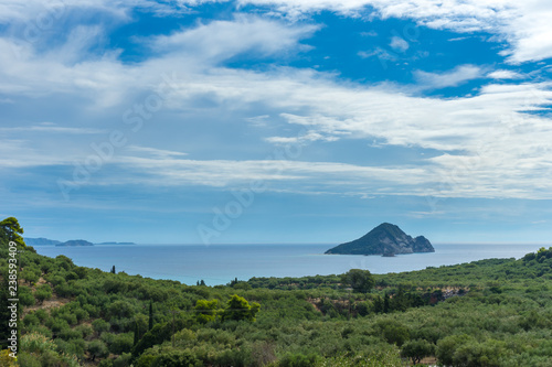 Greece, Zakynthos, Beautiful view on turtle island, Marathonissi behind green forest